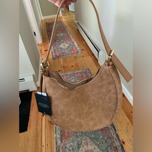 Faux suede crescent bag.